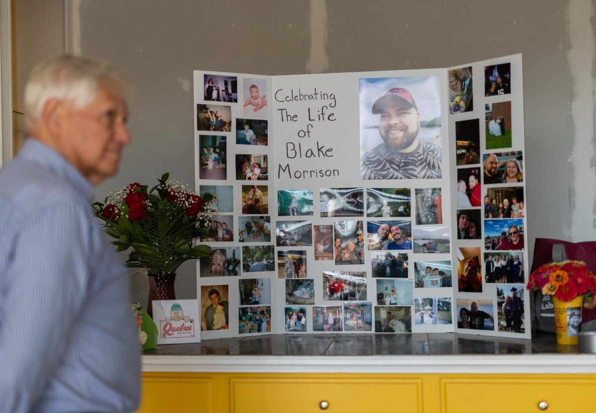 Former Carbondale city councilman Lee Fronabarger observes the memorial for Blake Morrison which consists of flowers, drawings and several pictures of different moments from his life Sept. 23, 2023 at the former Jerry’s Flower Boutique in Carbondale, Illinois.