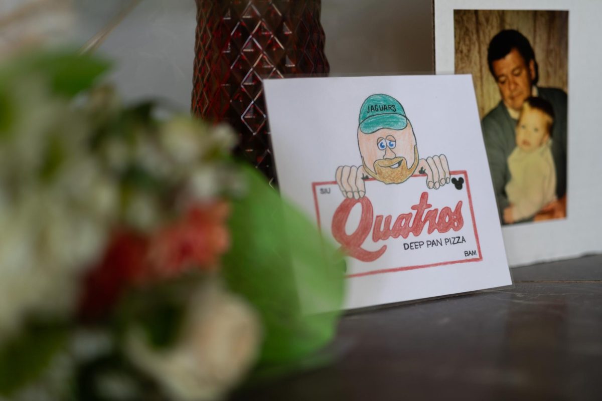 A doodle of Quatro’s mascot Q-Man, doodled by Annalies Dowell, sits on the interactive memorial for Blake Morrison Sept. 23, 2023 at the former Jerry’s Flower Boutique in Carbondale, Illinois.