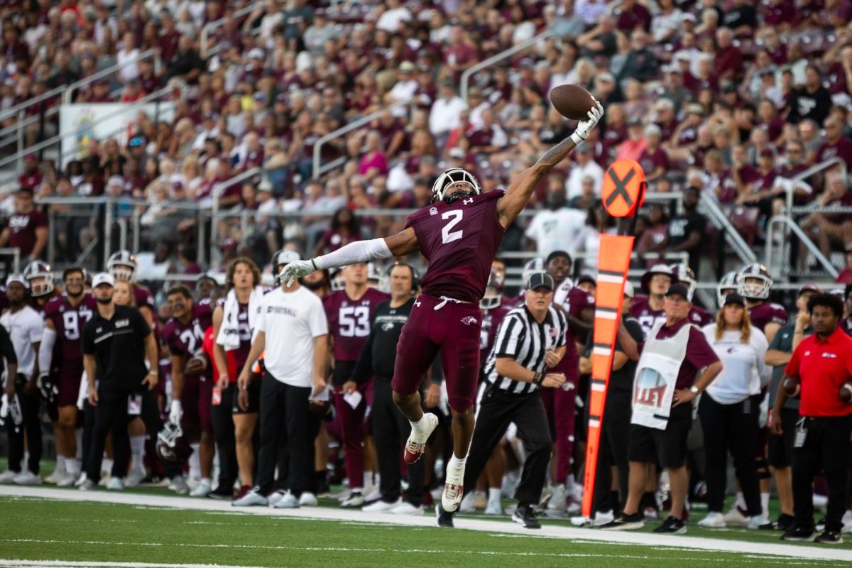 DAnte Cox (2) leaps into the air in an attempt to complete the pass from quarterback Nic Baker (8) as he approaches the end zone as the Salukis face Austin Peay at home for the season opener Aug. 2, 2023 at Saluki Stadium in Carbondale, Ill. 