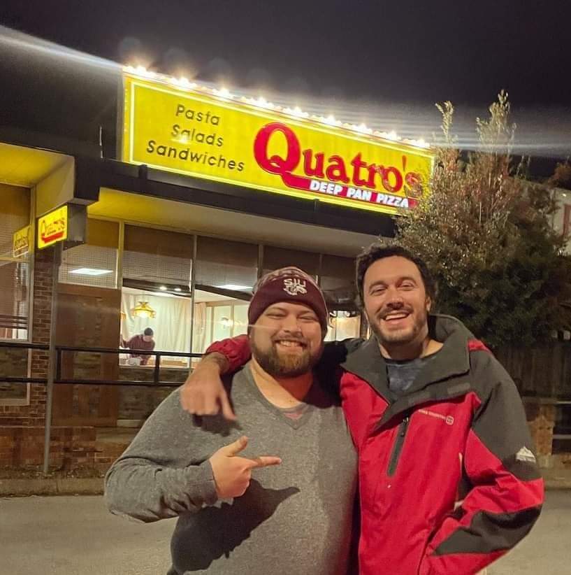 Blake Morrison (left) and his friend Peter (right) pose in front of Quatros Deep Pan Pizza in Carbondale, Illinois, February 2023. Photo provided by Nathan Colombo.
