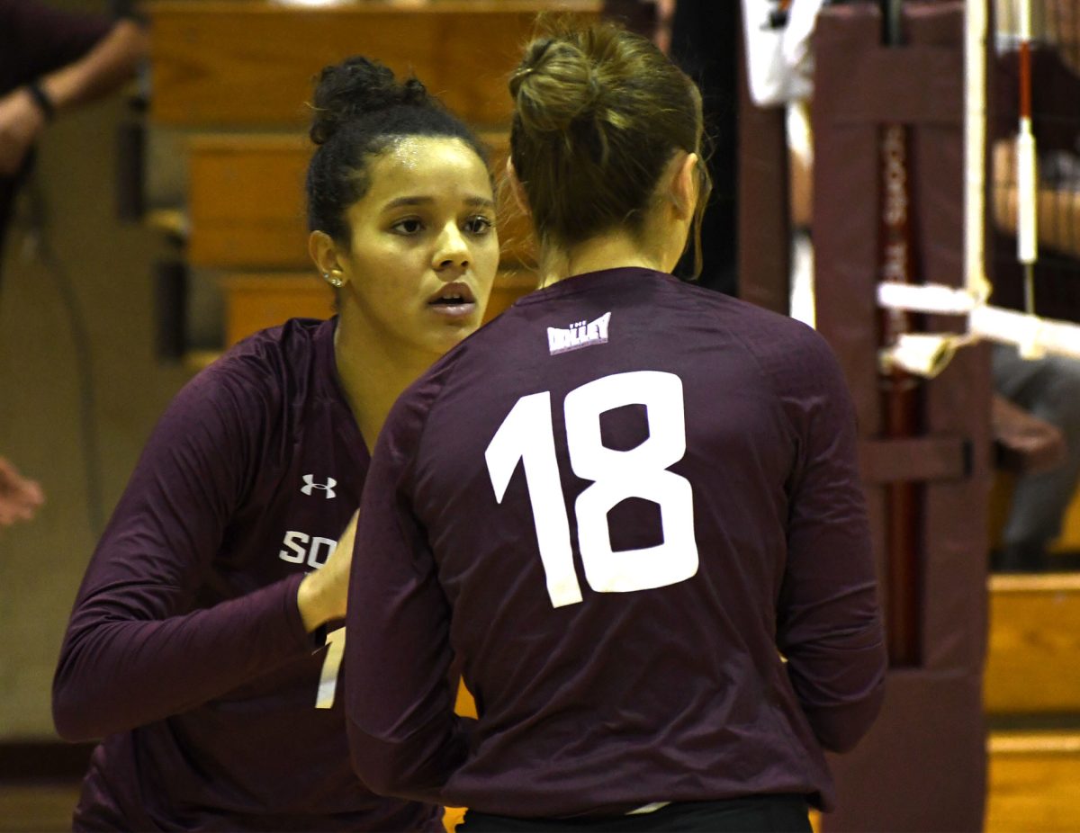 SIU Women’s Volleyball seniors Nataly Garcia (17) and Tatum Tornatta (18) high-five one another after winning a point against UIC at Davies Gym in Carbondale, IL on Saturday Oct. 21, 2023.