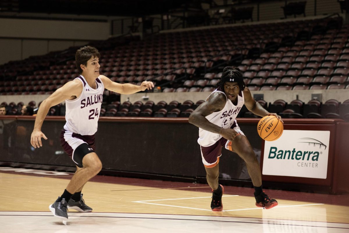 Kennard Davis (30) dribbles the ball towards the net as Trent Brown (24) approaches Oct. 16, 2023 at Banterra Center in Carbondale, Illinois.