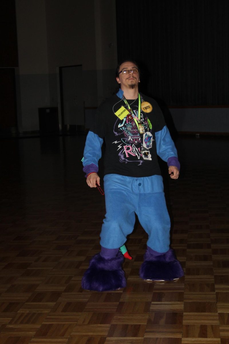 Saluki Furry Society Treasurer, Jonathan Kish dances in the middle of the Student Center Ballroom dance floor during the Spooky Saluki Costume Party on October 21, 2023 in Carbondale, Illinois.