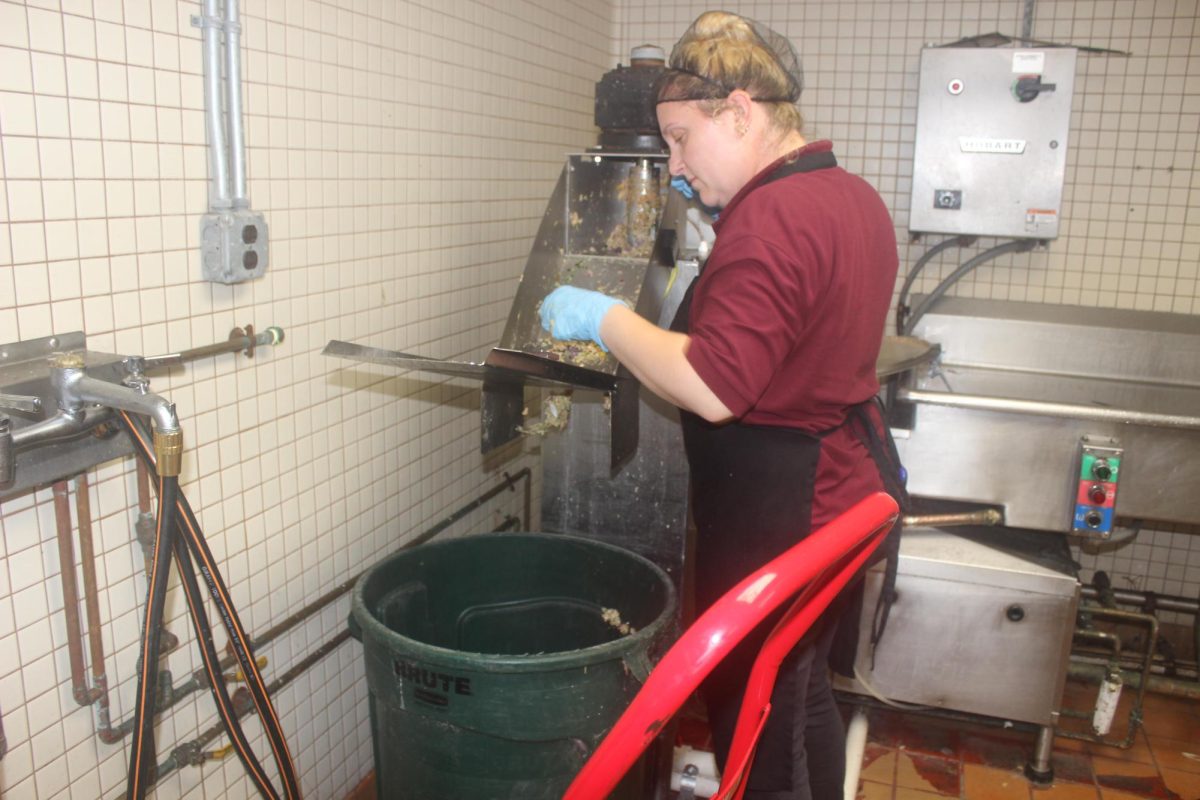 Culinary worker Jill Johnson prepares food leftovers for the SIU composter at Trueblood dining hall on Sept. 28, 2023.