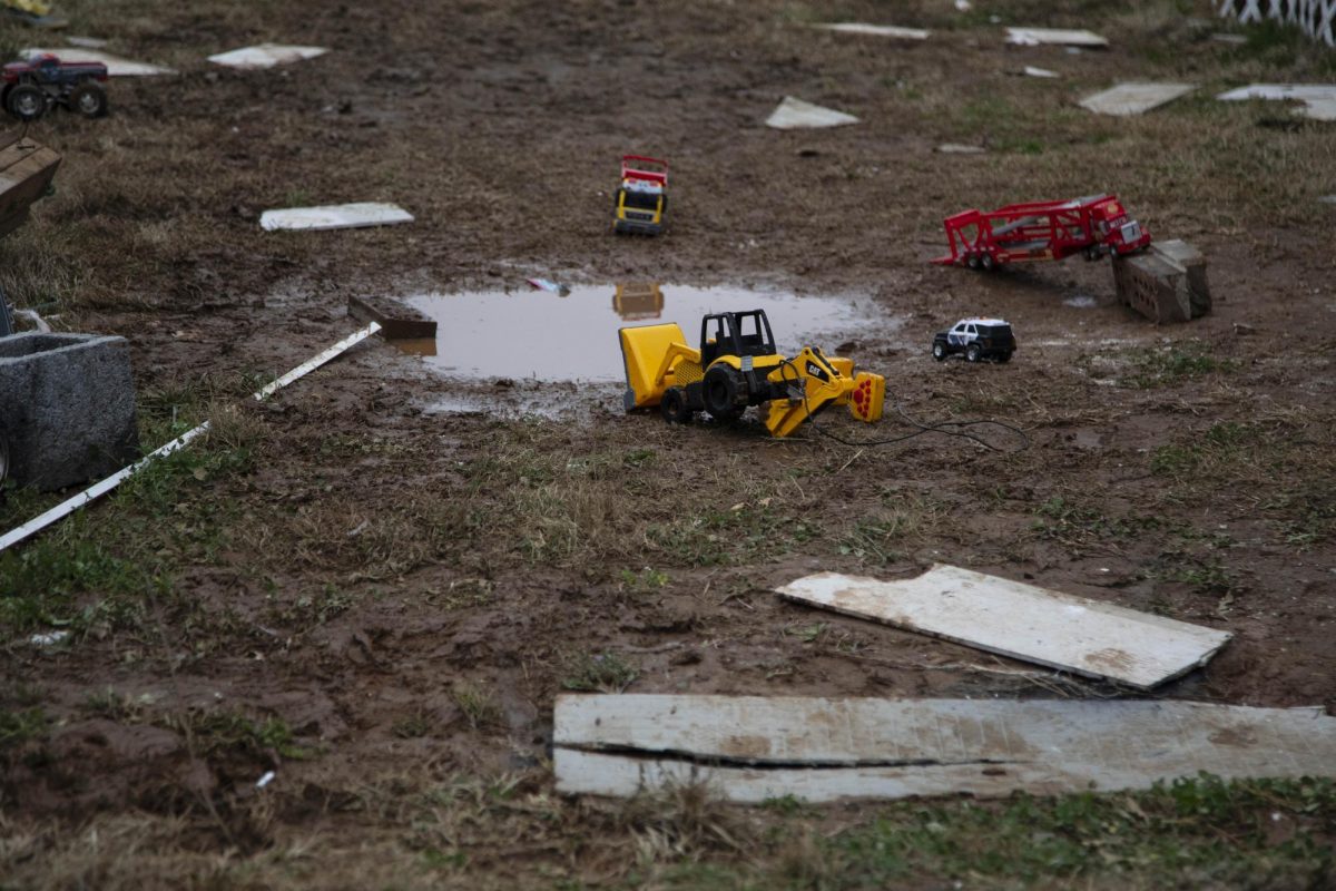 Toys trucks stand around a puddle and scattered debris the day after the Clarksville tornado Dec. 10, 2023 in Clarksville, Tennessee.