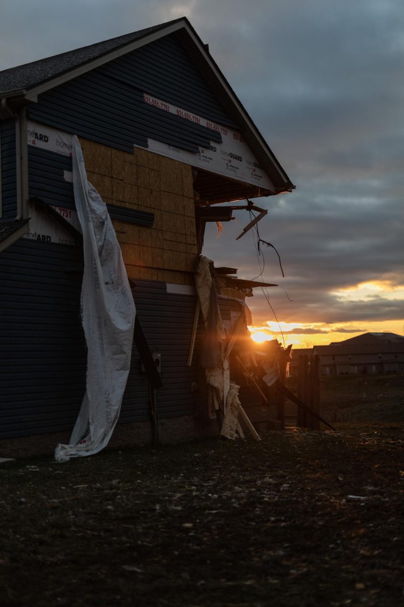 The sun peeks through the damaged corner of a house on Crisp Court after a tornado swept through the neighborhood the previous day Dec. 10, 2023 in Clarksville, Tennessee. 