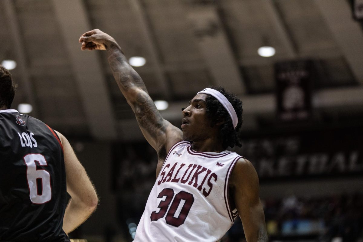 Kennard Davis (30) shoots a three from the corner as the Salukis host Austin Peay at home Dec. 12, 2023 at Banterra Center in Carbondale, Illinois.  