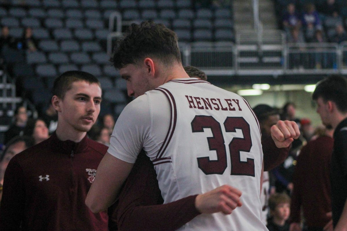 Jarrett Hensley (32) hugs mens basketball support staffer Sam Ebersold prior to Hensleys first career start against Evansville Feb. 25, 2024 at the Ford Center in Evansville, Indiana.
