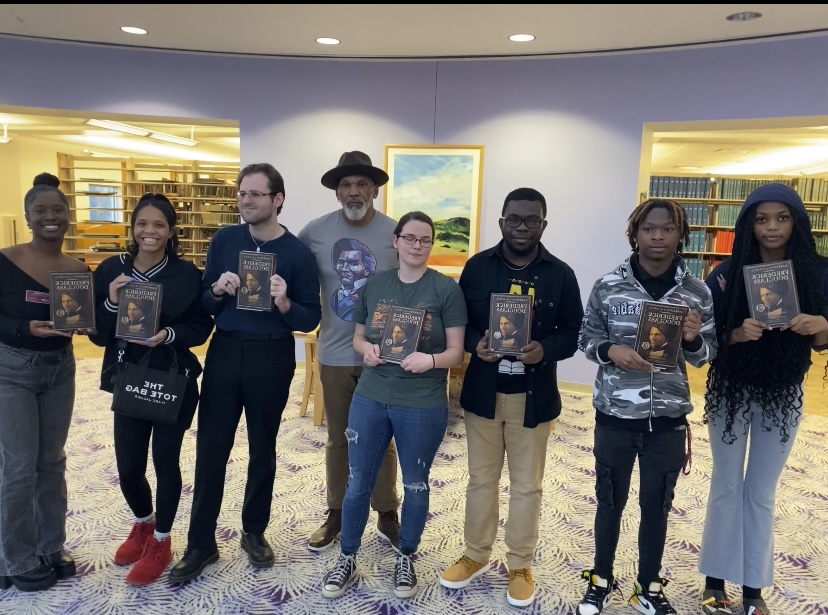 Kevin Douglass Green (fourth from left) visits with SIU students who hold copies of a book written by his great-great grandfather, noted abolitionist Frederick Douglas, in Carbondale, Illinois.