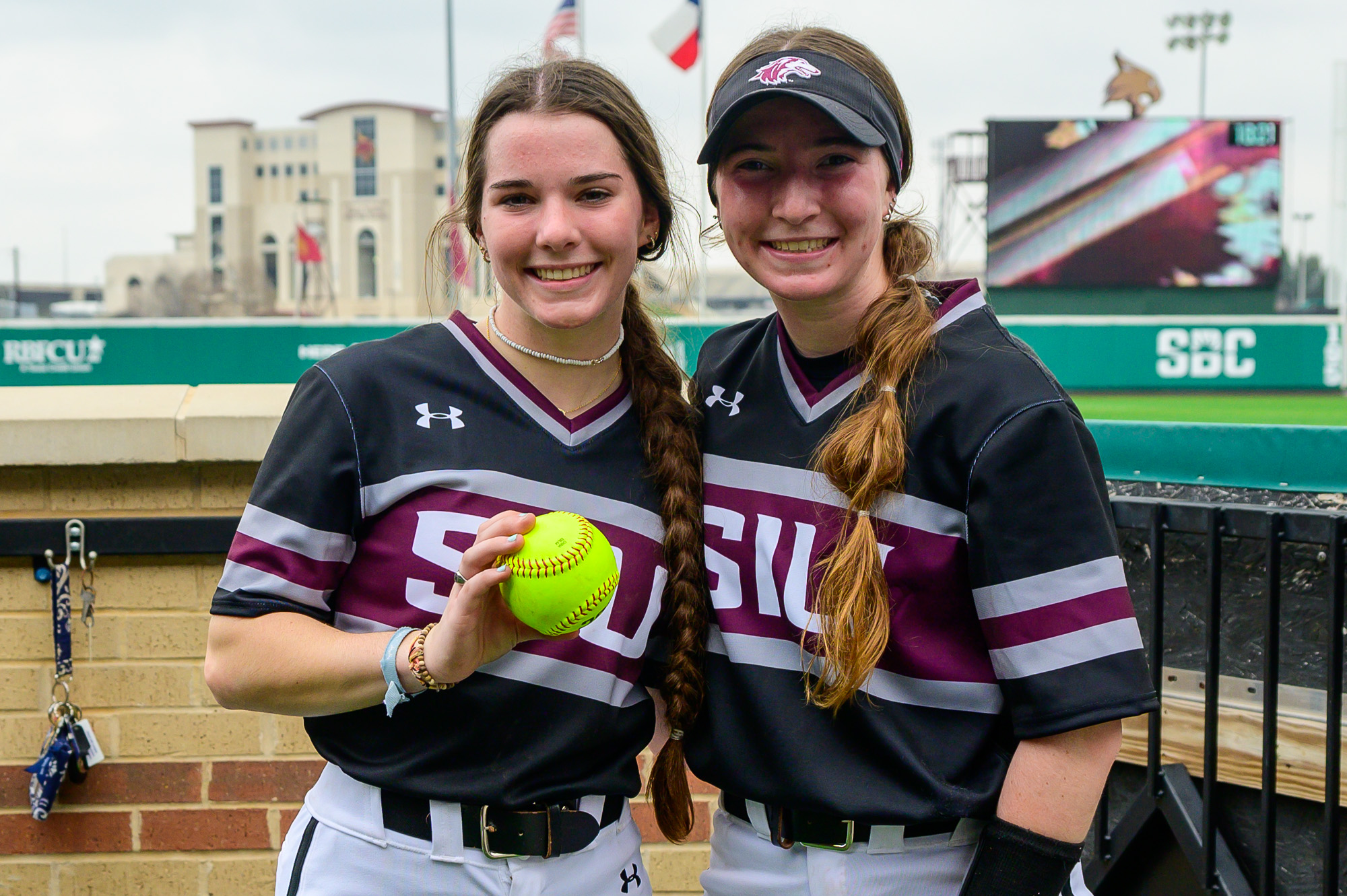 Pitcher Maddia Groff (left) and catcher Rylinn Groff (right) pose with the game ball from Maddias perfect game in their collegiate debut Feb. 9, 2024 at Bobcat Stadium in San Marcos, Texas. Photo provided by Saluki Athletics.