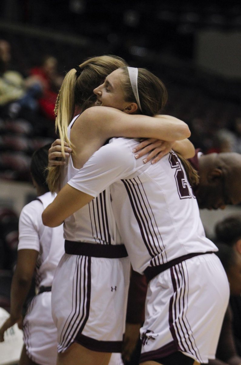 Adrianna Katcher (24) and Sydney Prochaska (3) hug after the SIU vs. Bradley University game Wednesday March 2, 2024 at the Banterra Center in Carbondale, Illinois. 