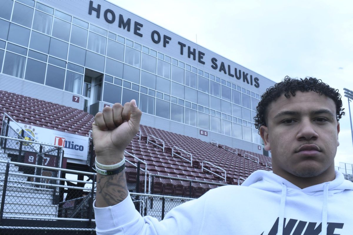 SIU Football freshman Kayleb Wagner (25) raises his fist with his bracelets to show support for the Dylan Buckner Foundation and all who struggle mentally at Saluki Stadium in Carbondale, IL Friday, Mar. 22, 2024. | 