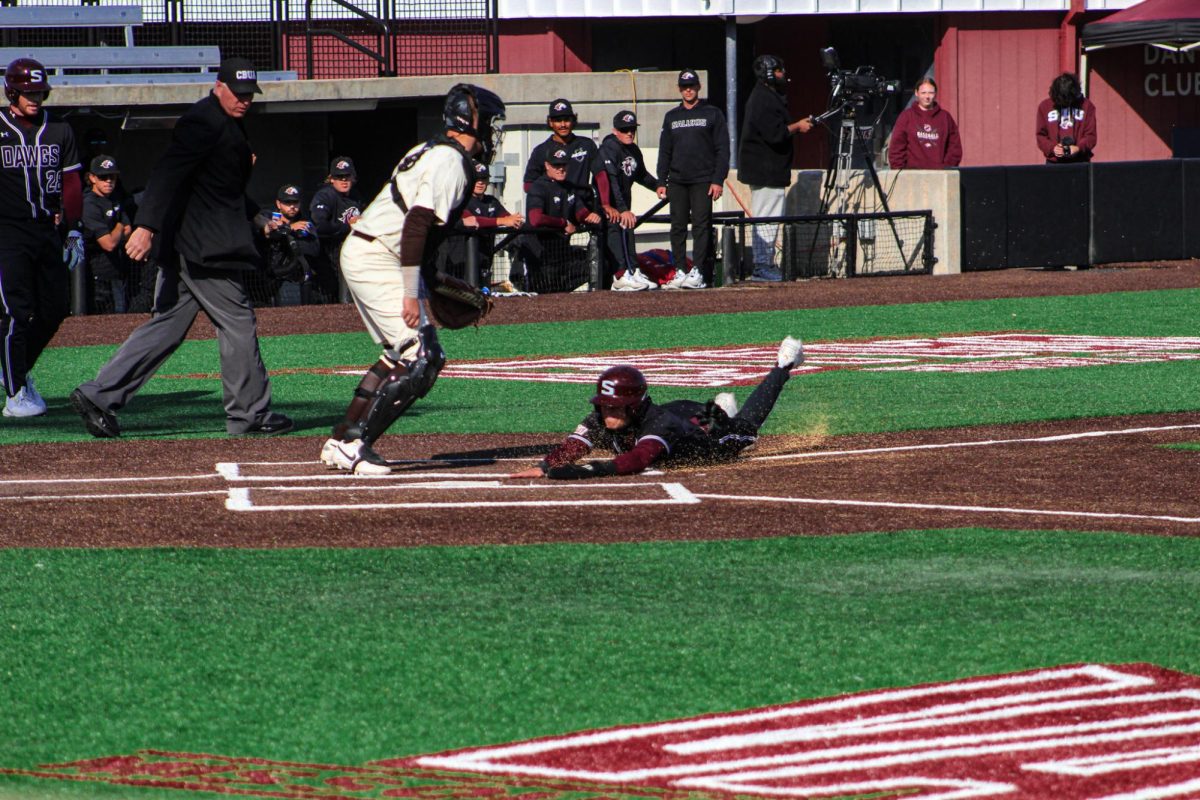 Nathan+Bandy+%287%29+slides+to+home+base+scoring+a+run+for+the+Salukis+during+the+Mar.+24%2C+2024+game+against+Valparaiso+University+at+Itchy+Jones+Stadium+in+Carbondale%2C+Illinois.+Libby+Phelps+%7C+%40libbyphelpsphotography