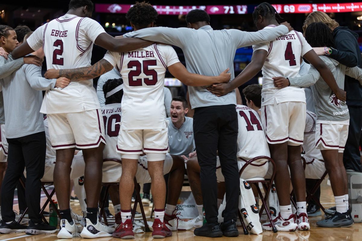 Head+Coach+Bryan+Mullins+speaks+to+Saluki+Basketball+in+a+media+timeout+as+the+Salukis+face+the+Flames+of+UIC+in+the+first+round+of+Arch+Madness+March+7%2C+2024+at+Enterprise+Center+in+St.+Louis%2C+Missouri.+