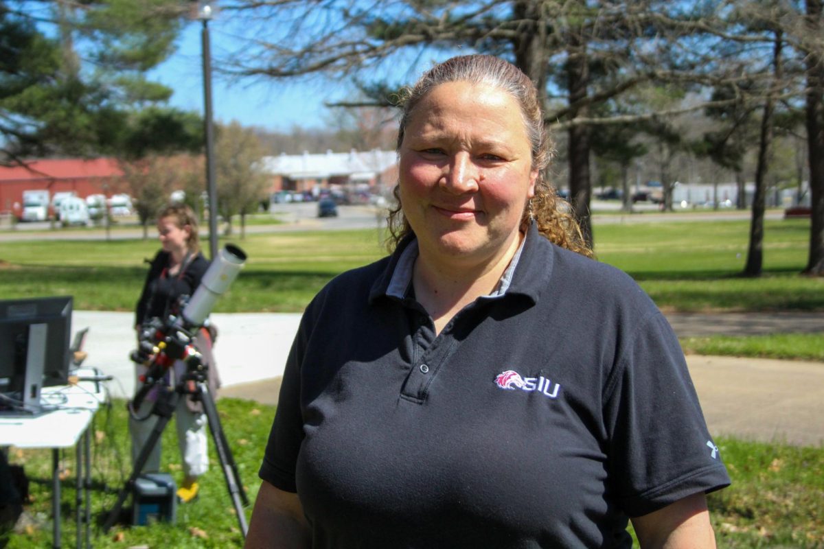 Corinne Brevik, co-chair of the SIU Eclipse Steering Committee’s subcommittee and participates in the Dynamic Eclipse Broadcast (DEB) research project, stands on Neckers Lawn at SIU March 27, 2024 in Carbondale, Illinois. @libbyphelpsphotography

