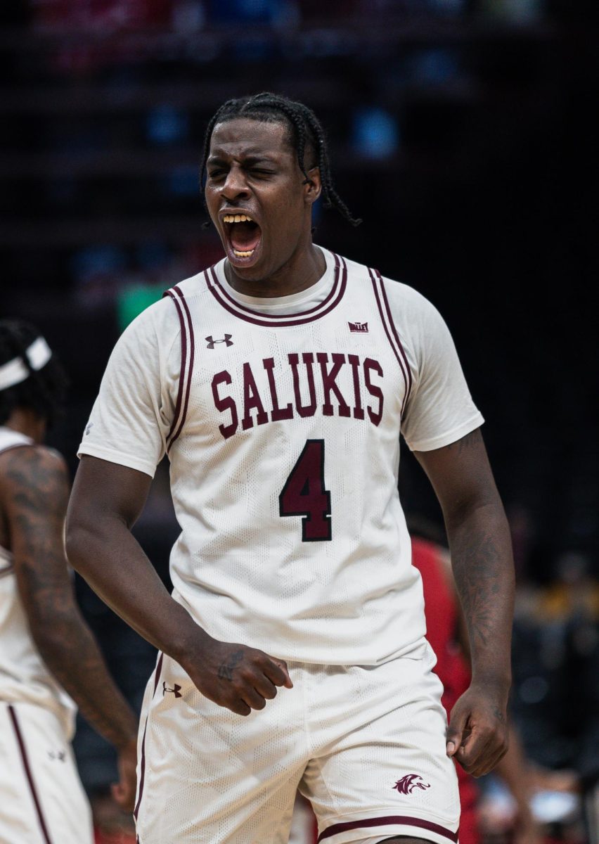 Clarence Rupert (4) yells in celebration as the Salukis come back from a double-digit deficit against the Flames of UIC March 7, 2024 at Enterprise Center in St. Louis, Missouri.