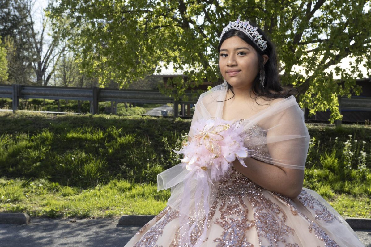 Zitlalli Tomas stands in her Quinceneara dress April 13, 2024, in Alto Pass, Illinois