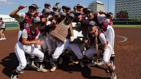 Saluki softball celebrates with both the regular season champions and Missouri Valley Conference champions trophies after clinching a win over Northern Iowa in the championship May 11, 2024 in Normal, Illinois. The dawgs earned their automatic bid to the NCAA tournament for the second year in a row. Photo courtesy of Saluki Athletics
