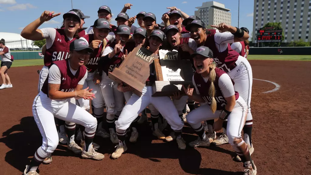 Saluki softball celebrates with both the regular season champions and Missouri Valley Conference champions trophies after clinching a win over Northern Iowa in the championship May 11, 2024 in Normal, Illinois. The dawgs earned their automatic bid to the NCAA tournament for the second year in a row. Photo courtesy of Saluki Athletics
