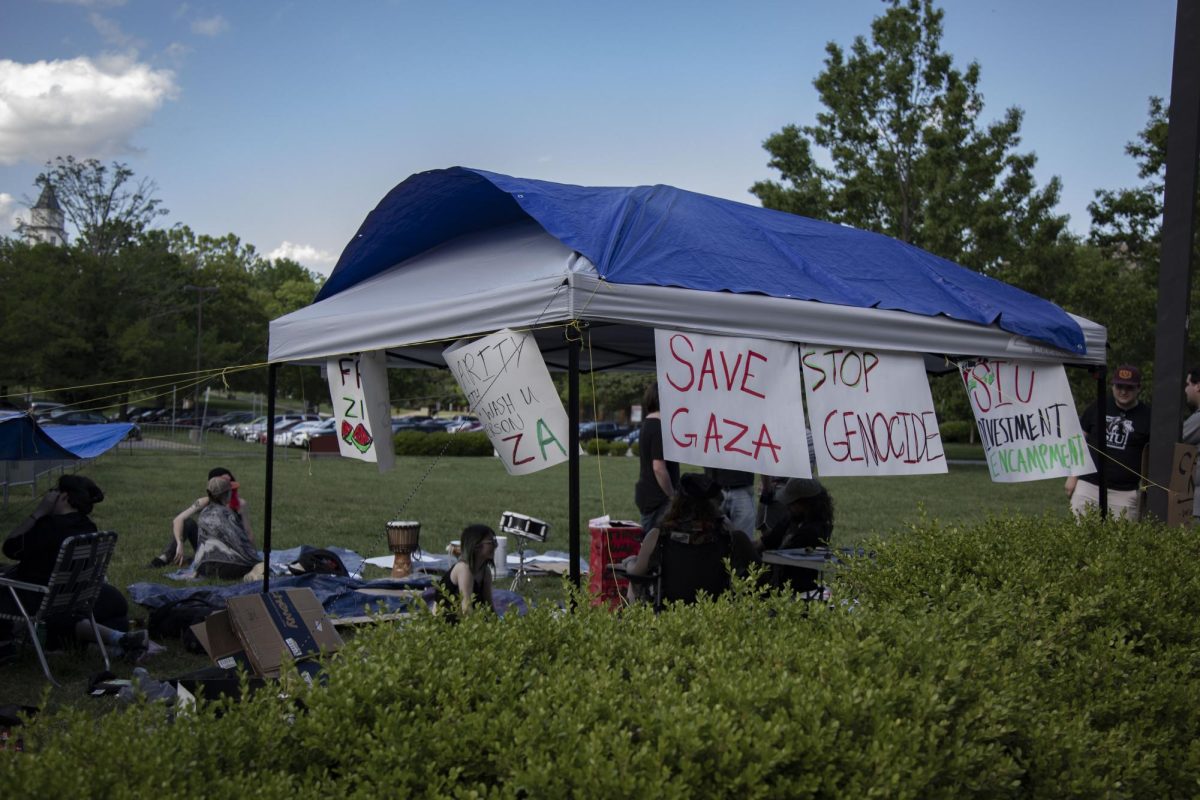 a tent stands on Morris Library lawn as protestors gather underneath April. 30, 2024 at Morris Library in Carbondale, Illinois.