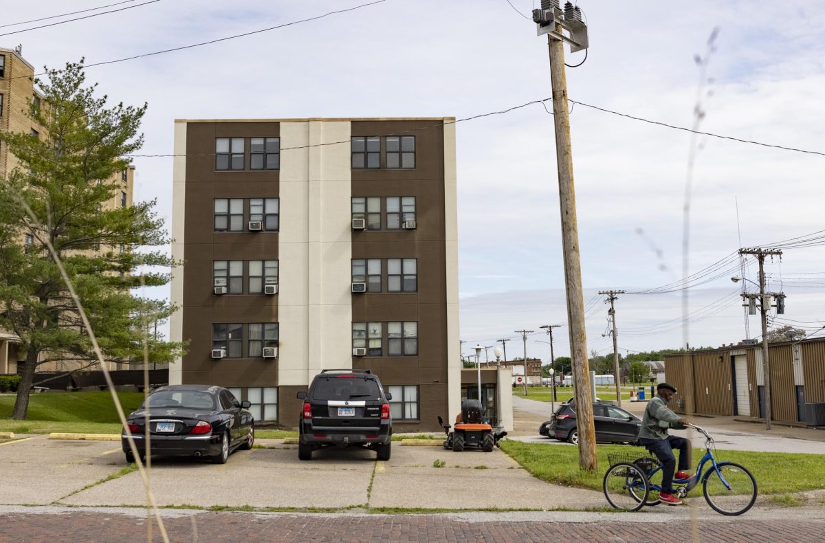 Rufus Barber rides his bike past a public housing building in Cairo, Illinois.