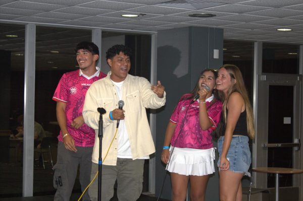 Jake Philbrick, William Sorto, Karen Coronado Bautista, Jada Ashcraft going word for word in karaoke, August 18, 2024 at Student Center SIU in Carbondale, Illinois.
