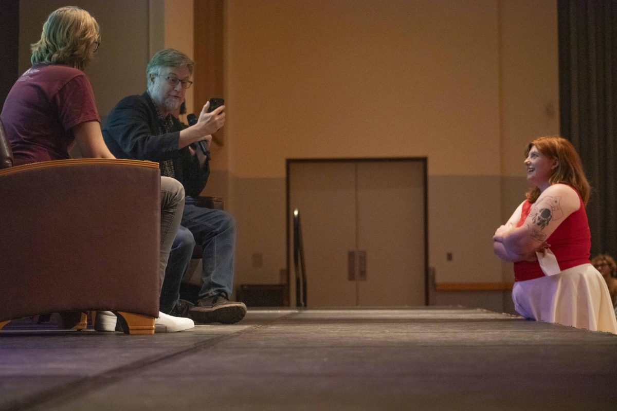 Dan Povenmire takes a video for a fan's family member as she watches on with a smile Sept. 19, 2024 at the Student Center in Carbondale, Illinois. 