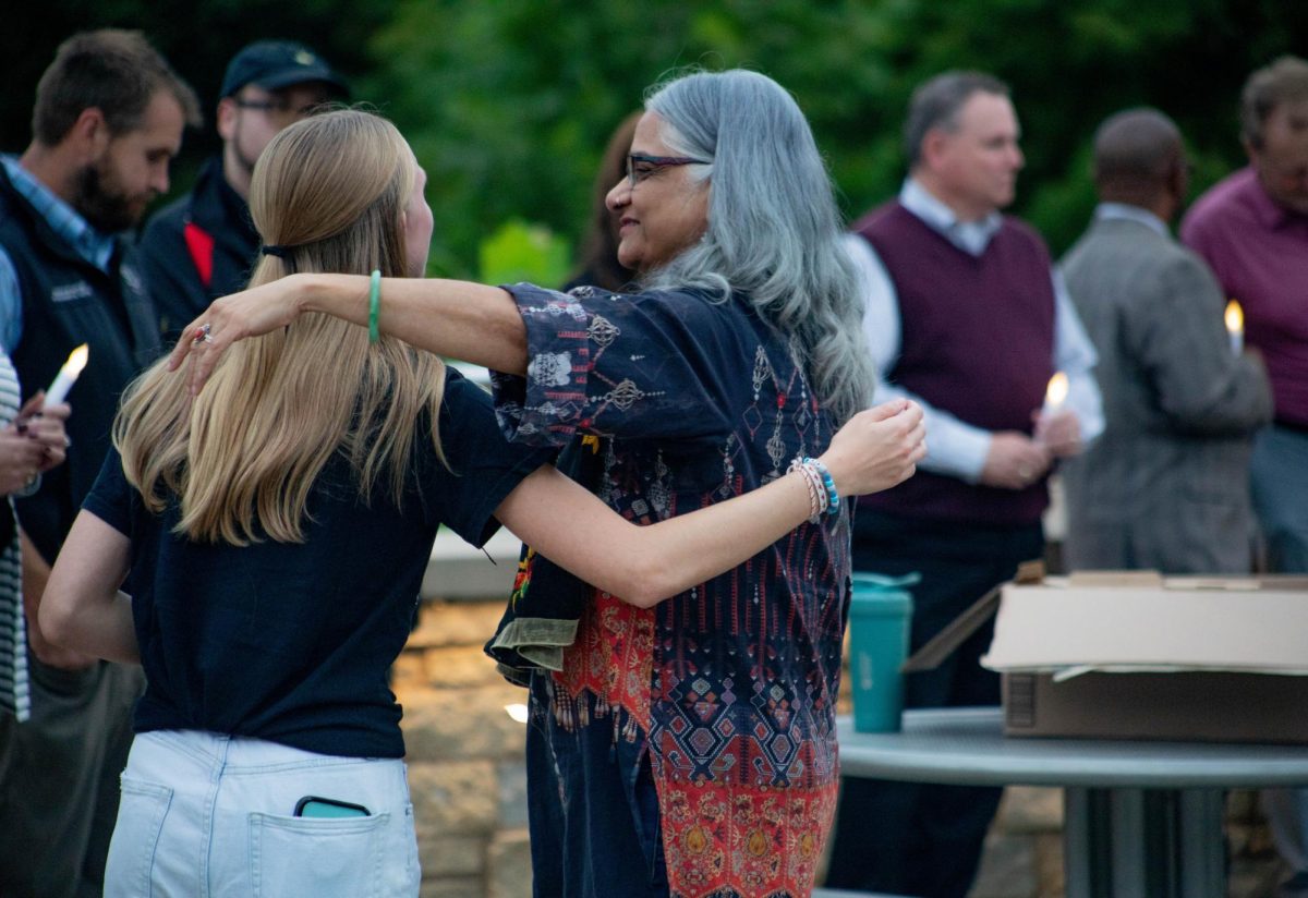 USG president Penny Bordewick reaches out for a hug from SIU faculty member after everyone's speeches were done at the “Once a Saluki, Always a Saluki” remembrance event Sept. 30, 2024 at Becker Pavilion on Campus Lake in Carbondale, Illinois. 