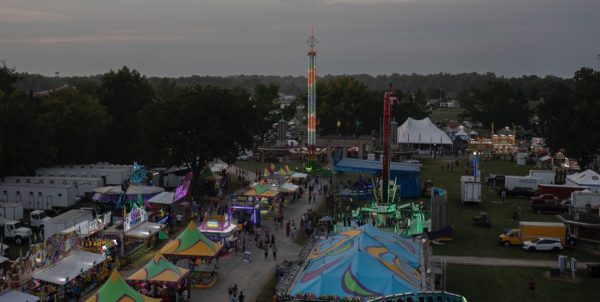 Fair attendees walk through the ride midway of the 102 annual Du Quoin State Fair Aug. 23, 2024 in Du Quoin, Illinois | @lyleegibbsphoto