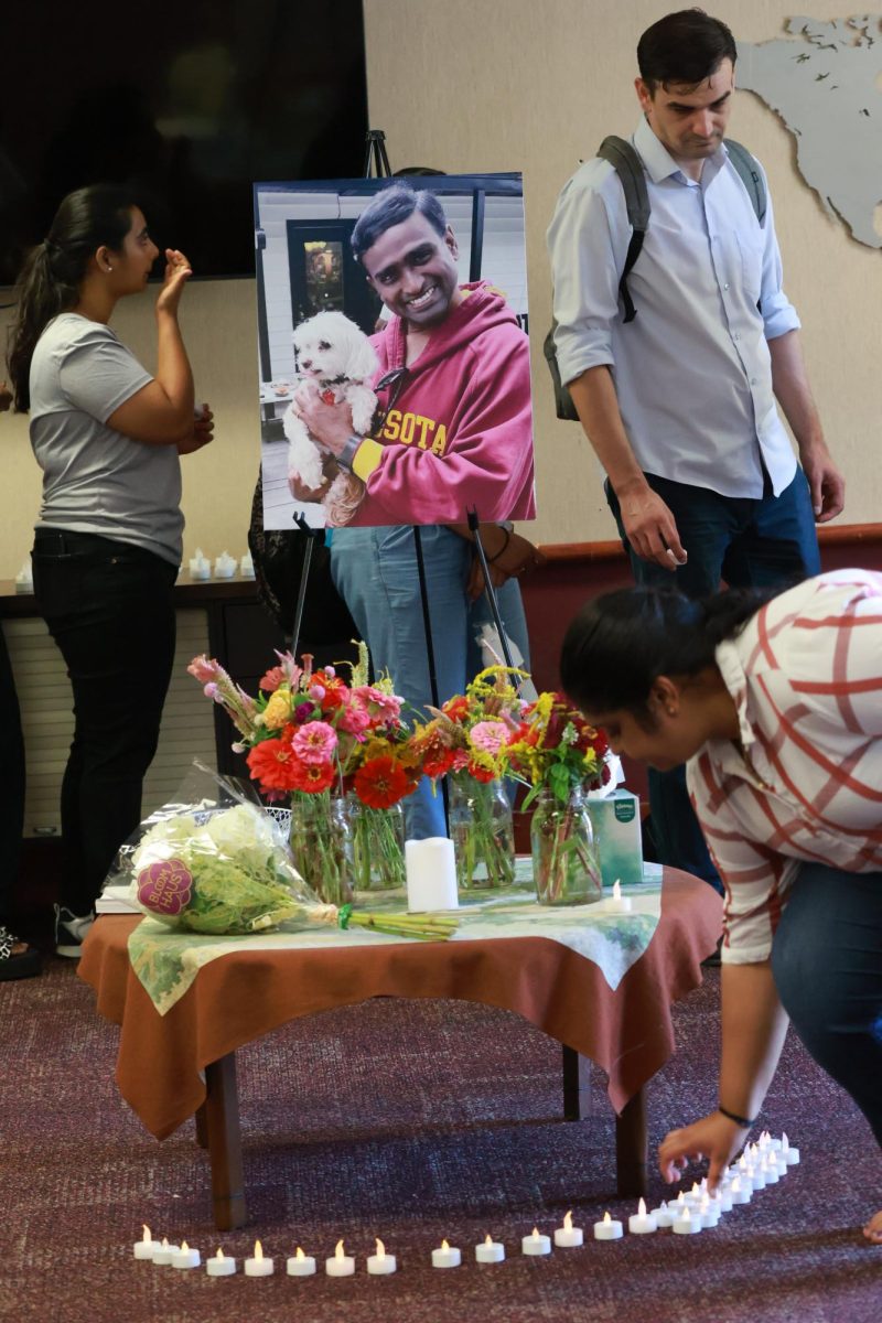 Bhavya Sri Billuri places a candle in respect for Ramesh Mutthina Sept. 18, 2024 at the Center for International Education Office in Carbondale, Illinois. Mutthina was a master student in health informatics and a member of the Indian Student Association.