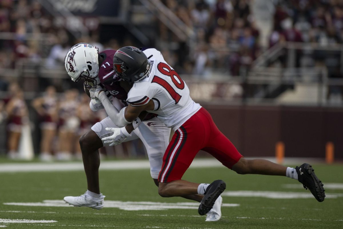 Nah'shawn Hezekiah (11) rushes the ball down the field as he is taken down by Redhawk Justus Johnson (18) as SIU faced SEMO in the annual War for the Wheel game Sept. 21, 2024 at Saluki Stadium in Carbondale, Illinois 