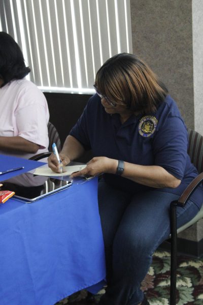 President of the Carbondale branch of the National Association for the Advancement of Colored People (NAACP) Linda Flowers assists students through the registration process at the voting registration event that was held by the Black Affairs Council and the Student Programming Council Sep. 3, 2024 in the Old Main Room at the Student Center in Carbondale, Illinois.  @libbyphelpsphotography
