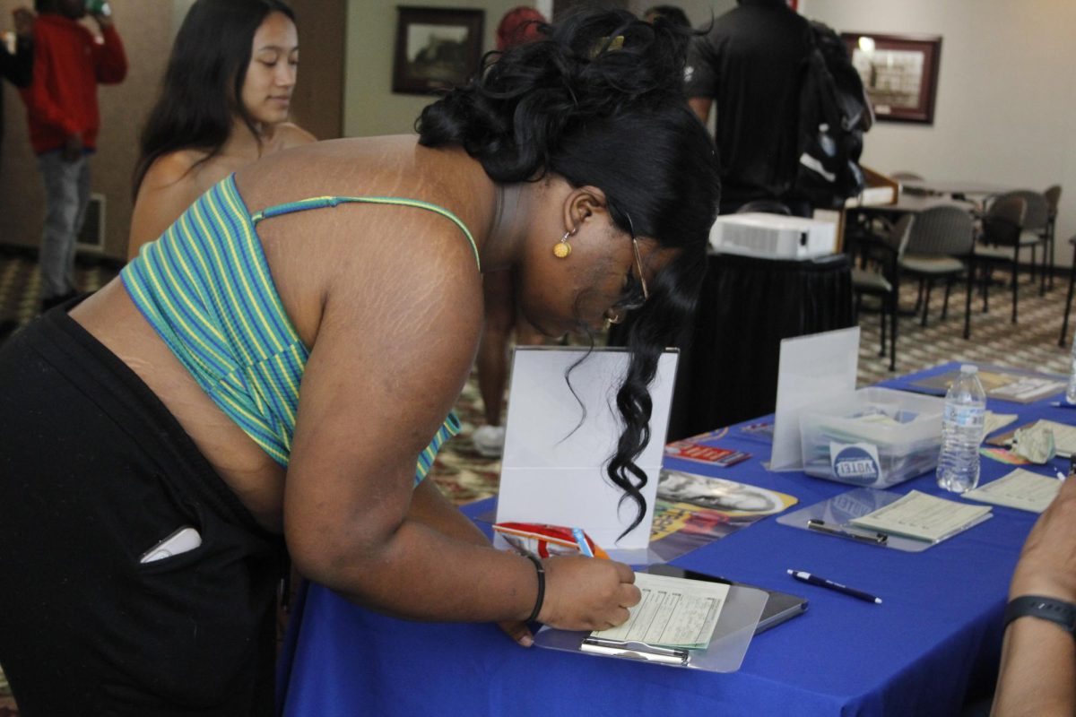 Michaela Black registers to vote during the voting registration event that was held by the Black Affairs Council and the Student Programming Council Sep. 3, 2024 in the Old Main Room at the Student Center in Carbondale, Illinois. @libbyphelpsphotography
