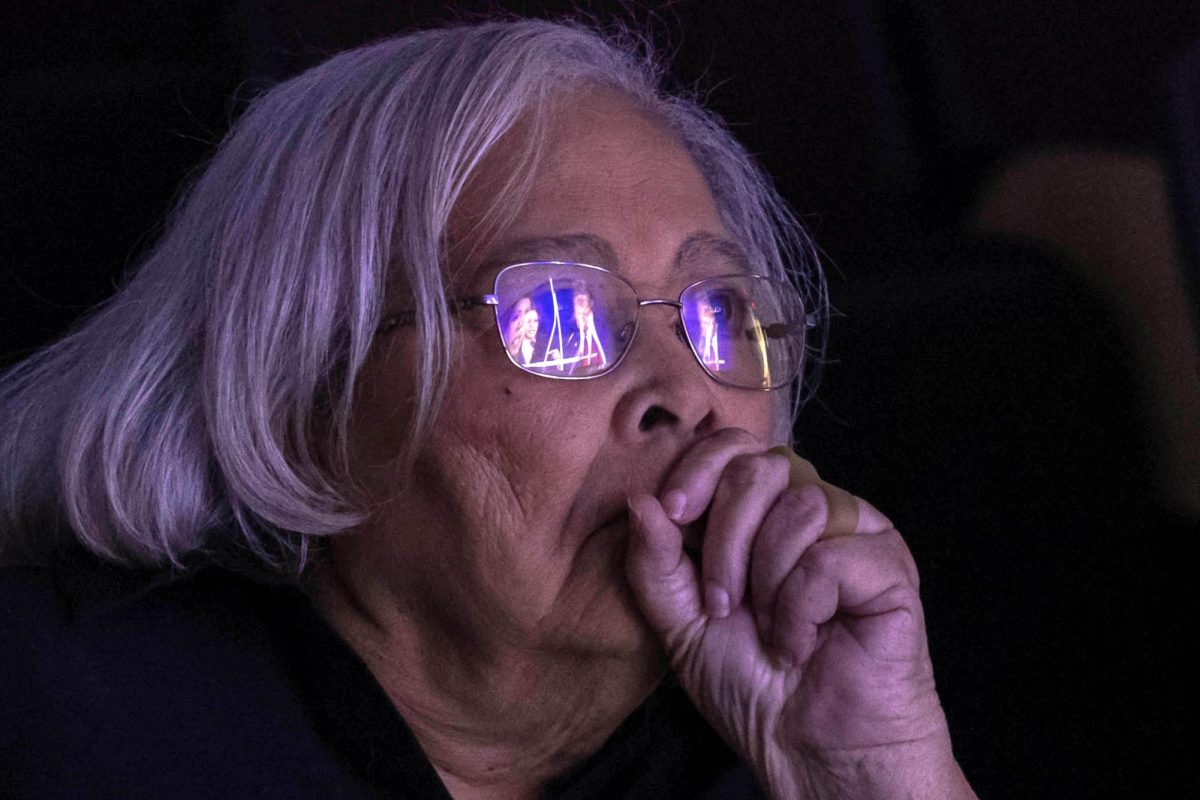 Presidential candidates Donald Trump and Kamala Harris reflect on the glasses of Marjorie Bryson, 85, as she
watches the presidential debate from the Faner Hall Museum Auditorium at a live watch party hosted by the
Carbondale Branch NAACP and Black Graduate Greek Council Sept. 10, 2024 in Carbondale, Illinois. Bryson, who is
casting her support for Kamala Harris, is a SIU alum and was in the Alpha Kappa Alpha (AKA) while enrolled.
 @lyleegibbsphoto