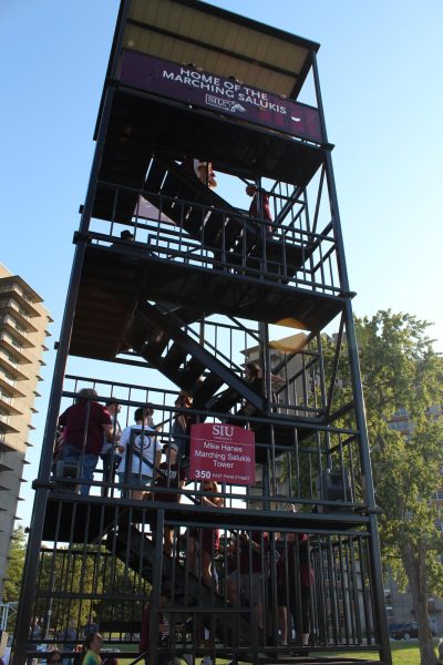 The new Mike Hanes Marching Saluki Tower is climbed by attendees of the event Oct. 11, 2024 at Sam Rinella Field in Carbondale, Illinois.