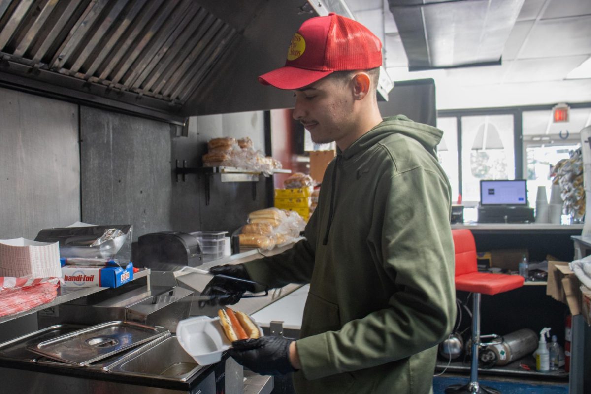 Elijah Krawczykowski makes a Chicago style hot dog Oct. 16, 2024 in Carbondale, Illinois.
