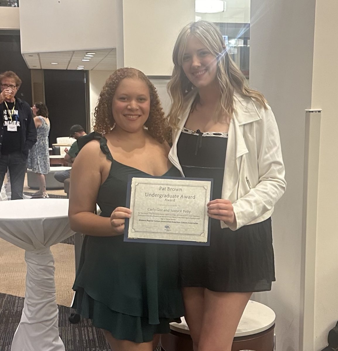 Justyce Petty (left) and Carly Gist (right) hold a certificate for the Pat Brown
Undergraduate Award Oct. 4, 2024 at DePaul University in Chicago, Illinois.
The award recognizes the best paper presented by an undergraduate at the
MPCA/ACA conference each year. Photo Provided.