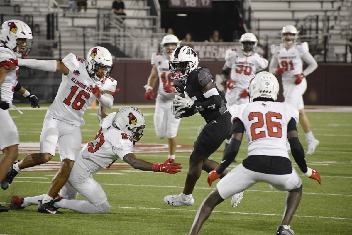 Second-year wide receiver Allen Middleton (15) attempts to navigate around a swarm of Illinois State defense during the annual Blackout Cancer game Oct. 5, 2024 at Saluki Stadium in Carbondale, Illinois.