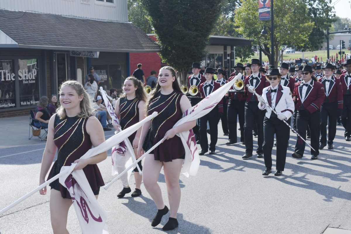 The Marching Salukis walk down the route during the SIU Homecoming Parade Oct. 12, 2024 in Carbondale, Illinois.