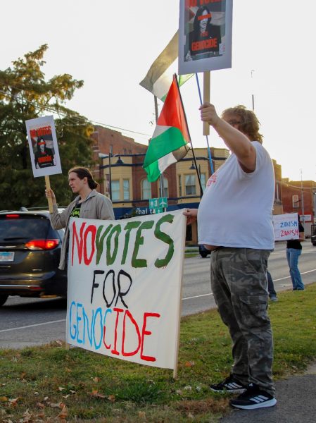 Protesters Gage McPhail (left) and Luke Herron-Titus (right) hold a No Votes for Genocide
banner during the No Votes for Genocide rally and march held by the Southern Illinois chapter
of Democratic Socalist of America Oct. 23, 2024 at the Carbondale Town Square Pavilion in
Carbondale, Illinois. Libby Phelps | @libbyphelpsphotography