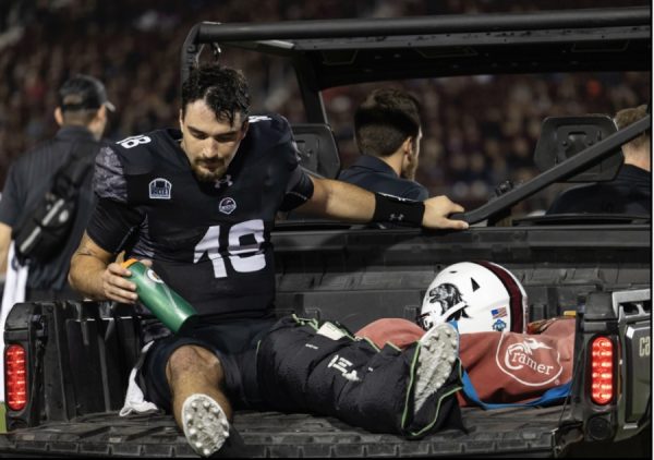 Quaterback Hunter Simmons(18) is driven off the field after an injury that later was revealed to be a broken leg as the Salukis faced the Redbirds of Illinois State at home Oct.5, 2024 at Saluki Stadium in Carbondale, Illinois. 