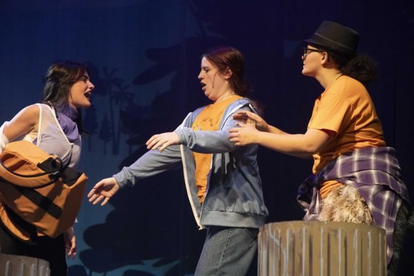 Edie Balester, who plays Annabeth Chase, snatches a backpack from Sydney Ryan and Ameriah Lockett, playing Percy and Grover respectively, while running through a full dress rehearsal before opening night Oct. 8, 2024 at the McLeod Theater in Carbondale, Illinois. “I think all of us have seen our chemistry build over this entire process and even as we near the end I think we still find moments on stage to create more of a connection with each other, and I think our relationships off stage have helped build the connections between characters so much more. I think it’s very apparent when you watch it,” Balester said. 