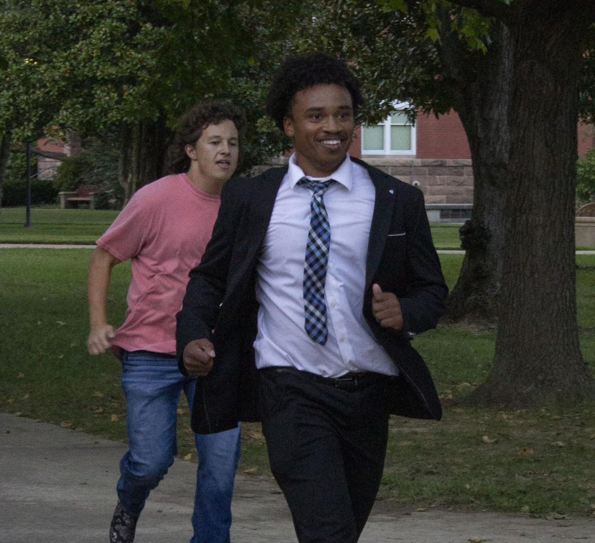 Sigma Chi pledge Rodney Brown runs through campus wearing heels during the third annual Walk a Mile in Their Shoes charity event Oct. 3, 2024 in Carbondale, Illinois.