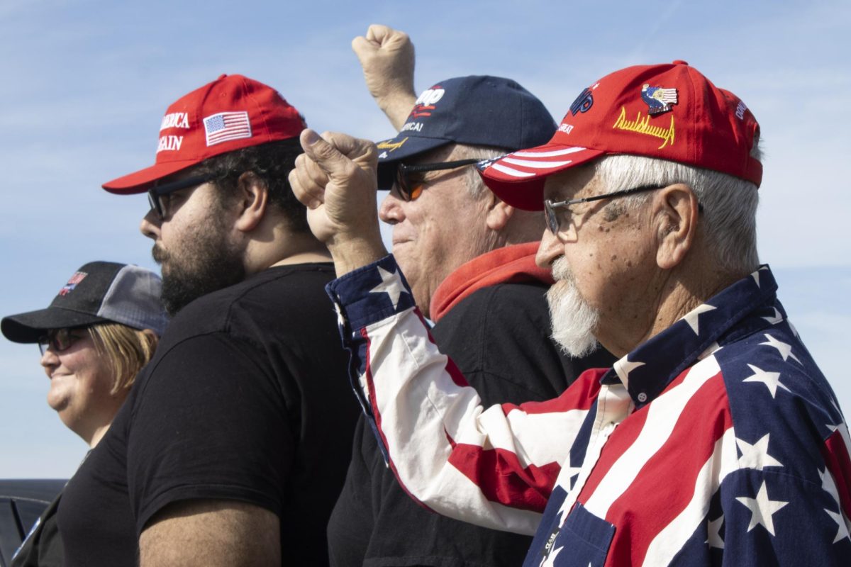 Clarence Skurat (right) raises his fist for a photograph at the MAGA Trump parade Nov. 2, 2024 at the Dillard’s parking lot in Marion, Illinois. Skurat said that securing the border, putting a stop to crime, and the economy were policy issues that were important to him this election. “I did vote for Trump. Always have and always will.”