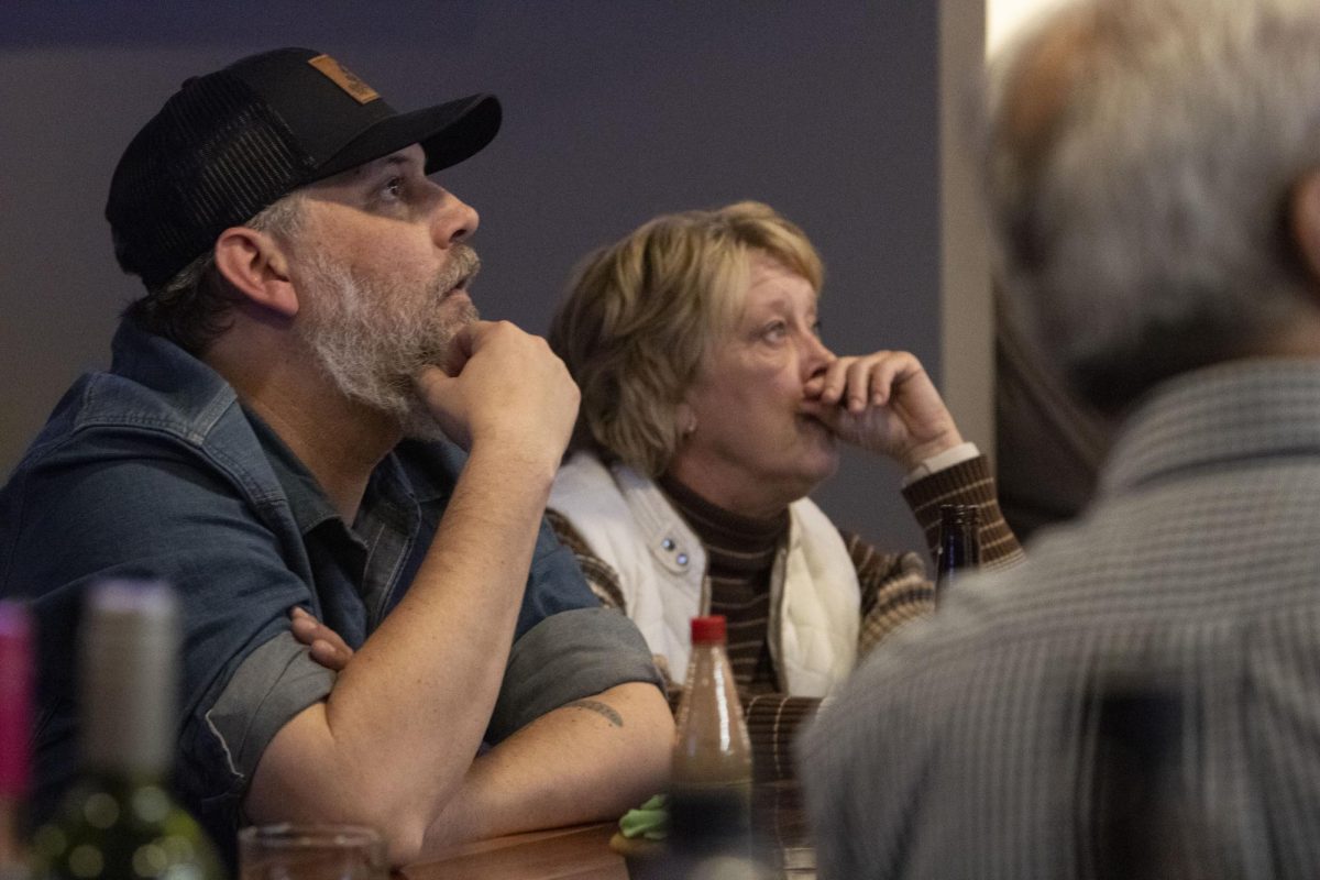 Brandon Ross and Tammy Kincannon drink a beer and watch the polls at a watch party Nov. 5, 2024 at the Grecian Steakhouse in Pinckneyville, Illinois.