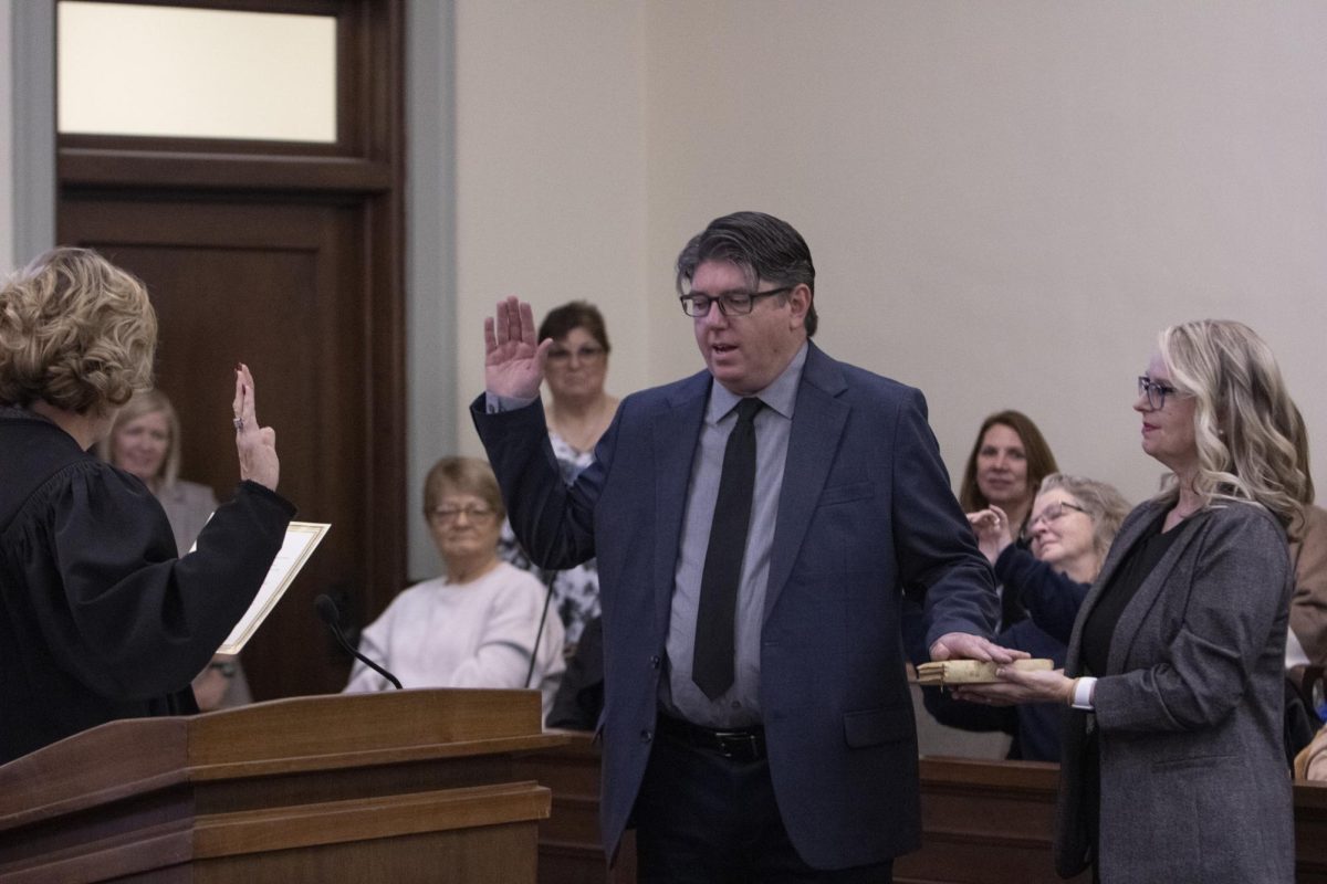 Circuit clerk Christian Hale (center) places his hand on his grandmother’s Bible, held by his wife Marsha Cascio-Hale (right) while being sworn into office by presiding judge Christy Solverson (left) Nov. 27, 2024 at the Jackson County Courthouse in Murphysboro, Illinois. 