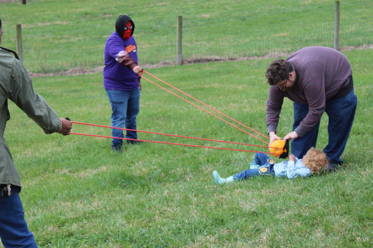 Austin and Willow Black prepare to slingshot their pumpkin into the field ahead at the Carbondale Pumpkin Smash in Carbondale, Illinois. Nov. 9, 2024.
