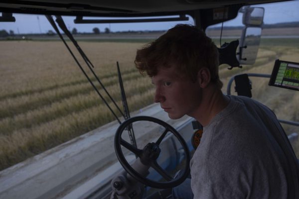 Wyatt Gerard, 23, looks out the window of the combine as he harvests a field of rice on his fathers farm Sept. 9, 2024 in McClure, Illinois. Wyatt is son to Blake Gerard, a fourth-generation rice farmer in the southernmost Illinois.