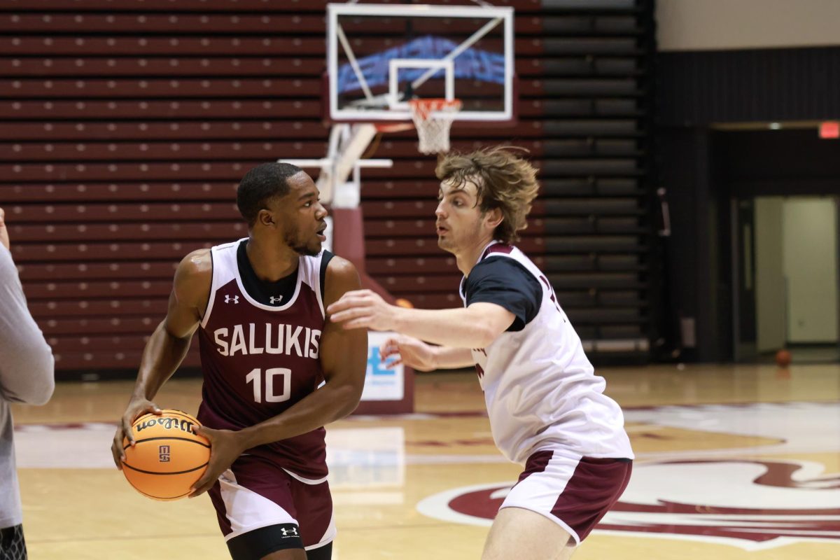 SIU Guard Damien Mayo Jr. looks to pass the ball during Tuesday’s scrimmage. October 14th, 2024 at Banterra Center in Carbondale, IL. Mayo Jr. is a transfer from Missouri State where he played in 60 games and started in 38.  Photo by Simeon Hardley.