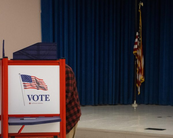 A Jackson County resident votes in the General Election as the American flag sits at rest behind them Nov. 5, 2024 at the Civic Center in Carbondale, Illinois.